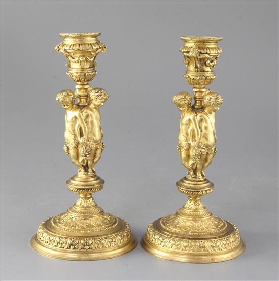 A pair of mid 19th century French ormolu candlesticks, height 8.25in.